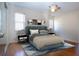 This is a staged bedroom with a blue bedframe, lamps, and pictures on the wall at 1730 W Del Webb Blvd, Sun City Center, FL 33573