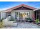 Charming home exterior with a cozy patio area and decorative landscaping, offering a welcoming and picturesque curb appeal at 1730 W Del Webb Blvd, Sun City Center, FL 33573