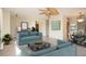 Bright living room featuring tile floors, neutral paint, modern furniture, and open layout at 1730 W Del Webb Blvd, Sun City Center, FL 33573