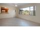 Bright living room with tile floors and view to kitchen through pass-through window to outside patio at 1730 W Del Webb Blvd, Sun City Center, FL 33573