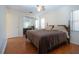 Comfortable main bedroom with mirrored closet doors, ceiling fan, and window with vertical blinds, offering practical living at 1730 W Del Webb Blvd, Sun City Center, FL 33573