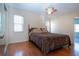 Cozy main bedroom features a comfortable bed, ample closet space, and warm wood floors, creating a relaxing retreat at 1730 W Del Webb Blvd, Sun City Center, FL 33573