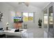 Bright sun room featuring tiled floors, a large window, and an easel with art display, creating an ideal workspace at 1730 W Del Webb Blvd, Sun City Center, FL 33573