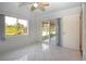 Sunlit room boasting tile floors, sliding glass doors, and serene lake views, perfect for relaxing and enjoying nature at 1730 W Del Webb Blvd, Sun City Center, FL 33573