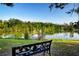 Scenic water view featuring a tranquil pond, a charming dock, and a decorative bench for enjoying the serene natural surroundings at 1730 W Del Webb Blvd, Sun City Center, FL 33573