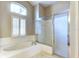 Bright bathroom featuring a glass-enclosed shower, a separate tub, and tiled flooring at 17320 Hubers Ct, Odessa, FL 33556