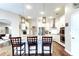 Bright kitchen featuring a granite island with pendant lighting, white cabinets, and stainless appliances at 17320 Hubers Ct, Odessa, FL 33556