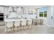 Bright kitchen featuring a large island, stylish pendant lighting, and stainless steel appliances at 17420 Moonflower Dr # 103, Venice, FL 34293
