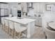 Modern kitchen with a spacious island, sleek cabinetry, stainless steel appliances, and an adjacent dining area at 17420 Moonflower Dr # 103, Venice, FL 34293