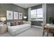 Serene bedroom featuring a daybed, large window with water view, and neutral decor for a tranquil atmosphere at 17420 Moonflower Dr # 202, Venice, FL 34293