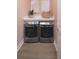 Efficient laundry area with front-loading washer and dryer, white countertops, and neutral decor at 17420 Moonflower Dr # 202, Venice, FL 34293
