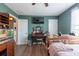 Bright bedroom featuring wood floors, tv, vanity, and modern interior design at 1757 Broad Winged Hawk Dr, Ruskin, FL 33570