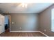 Neutral bedroom featuring a ceiling fan, hard wood floors, and an open door at 1757 Broad Winged Hawk Dr, Ruskin, FL 33570