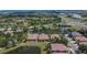 Lovely community aerial view of houses situated near a scenic pond, landscaped grounds, and a main road at 178 Shell Falls Dr, Apollo Beach, FL 33572