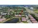 An attractive community aerial view of houses situated amidst lush landscaping, serene lakes, and nearby roadways at 178 Shell Falls Dr, Apollo Beach, FL 33572