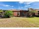 Grassy backyard featuring a screened lanai and mature trees along a home's exterior at 178 Shell Falls Dr, Apollo Beach, FL 33572