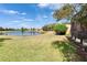Lush backyard of a home overlooking a serene lake with a screened-in lanai at 178 Shell Falls Dr, Apollo Beach, FL 33572