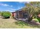 A home's screened lanai and exterior, surrounded by lush greenery and well-maintained landscaping at 178 Shell Falls Dr, Apollo Beach, FL 33572