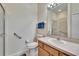 Well-lit bathroom features a large mirror, wooden vanity, toilet, and glass-enclosed shower at 178 Shell Falls Dr, Apollo Beach, FL 33572