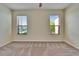 Spacious bedroom with neutral carpet, walls, and natural light from two windows at 178 Shell Falls Dr, Apollo Beach, FL 33572