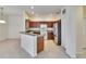 Eat-in kitchen featuring dark wood cabinets, a stainless-steel refrigerator, and breakfast bar at 178 Shell Falls Dr, Apollo Beach, FL 33572