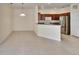 Eat-in kitchen showcasing tile floors, stainless steel refrigerator, and dark wood cabinets at 178 Shell Falls Dr, Apollo Beach, FL 33572