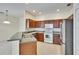 Kitchen showcasing stainless steel appliances, dark wood cabinetry, and tile flooring at 178 Shell Falls Dr, Apollo Beach, FL 33572