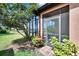 View of screened lanai with outdoor seating area accessible from the backyard at 178 Shell Falls Dr, Apollo Beach, FL 33572