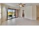 Bright living room with tile floors, sliding glass doors to a patio, and a ceiling fan at 178 Shell Falls Dr, Apollo Beach, FL 33572