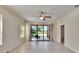 Bright living room featuring a ceiling fan, tiled flooring, and sliding glass doors to an outdoor area at 178 Shell Falls Dr, Apollo Beach, FL 33572