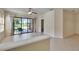 Bright living room with tiled floors, a ceiling fan, and sliding glass doors to the patio at 178 Shell Falls Dr, Apollo Beach, FL 33572