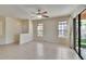 Spacious living room with large windows, a ceiling fan, and sliding glass door access to an outdoor area at 178 Shell Falls Dr, Apollo Beach, FL 33572