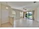 Sunlit living room with tile floors, multiple windows, and sliding glass doors to an outdoor patio at 178 Shell Falls Dr, Apollo Beach, FL 33572