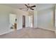 Main bedroom featuring a ceiling fan, plush carpet, walk-in closet, and bathroom access at 178 Shell Falls Dr, Apollo Beach, FL 33572