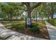 Community trail system with paved sidewalks, lush landscaping, and mature trees at 178 Shell Falls Dr, Apollo Beach, FL 33572
