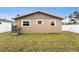 Home's exterior showcasing a well-manicured lawn and fenced backyard at 1819 Shore Acres Ne Blvd, St Petersburg, FL 33703