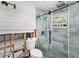 Partially renovated bathroom features a modern glass shower and toilet, and an unfinished wall at 1819 Shore Acres Ne Blvd, St Petersburg, FL 33703