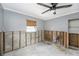 Bedroom renovation featuring raw concrete walls, modern windows, and a contemporary ceiling fan at 1819 Shore Acres Ne Blvd, St Petersburg, FL 33703