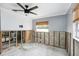 Bedroom renovation showcasing shiplap wall, raw concrete, and modern ceiling fan; bathroom visible in adjacent room at 1819 Shore Acres Ne Blvd, St Petersburg, FL 33703