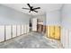 Spacious bedroom with ceiling fan is partially renovated, revealing studs and concrete flooring at 1819 Shore Acres Ne Blvd, St Petersburg, FL 33703