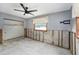 Partially renovated bedroom has an open closet, concrete walls, and a modern ceiling fan at 1819 Shore Acres Ne Blvd, St Petersburg, FL 33703