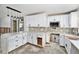 Bright kitchen with white cabinets, quartz countertops, and mosaic backsplash at 1819 Shore Acres Ne Blvd, St Petersburg, FL 33703
