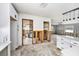 Open concept kitchen with white cabinets, quartz countertops, and adjacent living space at 1819 Shore Acres Ne Blvd, St Petersburg, FL 33703