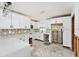 Modern kitchen featuring white cabinets, quartz countertops, and designer backsplash at 1819 Shore Acres Ne Blvd, St Petersburg, FL 33703