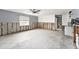 Open-concept living area with tile flooring transitioning into kitchen with modern white cabinetry at 1819 Shore Acres Ne Blvd, St Petersburg, FL 33703