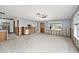Open-concept space with tiled floor and exposed wall studs leading into the kitchen at 1819 Shore Acres Ne Blvd, St Petersburg, FL 33703