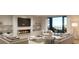Cozy living room features a fireplace, comfortable seating, and access to a private balcony overlooking a serene lake at 1874 Stevenson Ave, Clearwater, FL 33755
