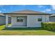 Simple backyard and patio area with green grass and a well-maintained white exterior at 19437 Ship Wheel Way, Land O Lakes, FL 34638