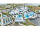 Gorgeous aerial view of clubhouse with a luxurious pool, seating, and lush landscaping at 19437 Ship Wheel Way, Land O Lakes, FL 34638