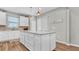 Bright kitchen island features white cabinets and lots of counter space, perfect for food preparation and casual dining at 19437 Ship Wheel Way, Land O Lakes, FL 34638